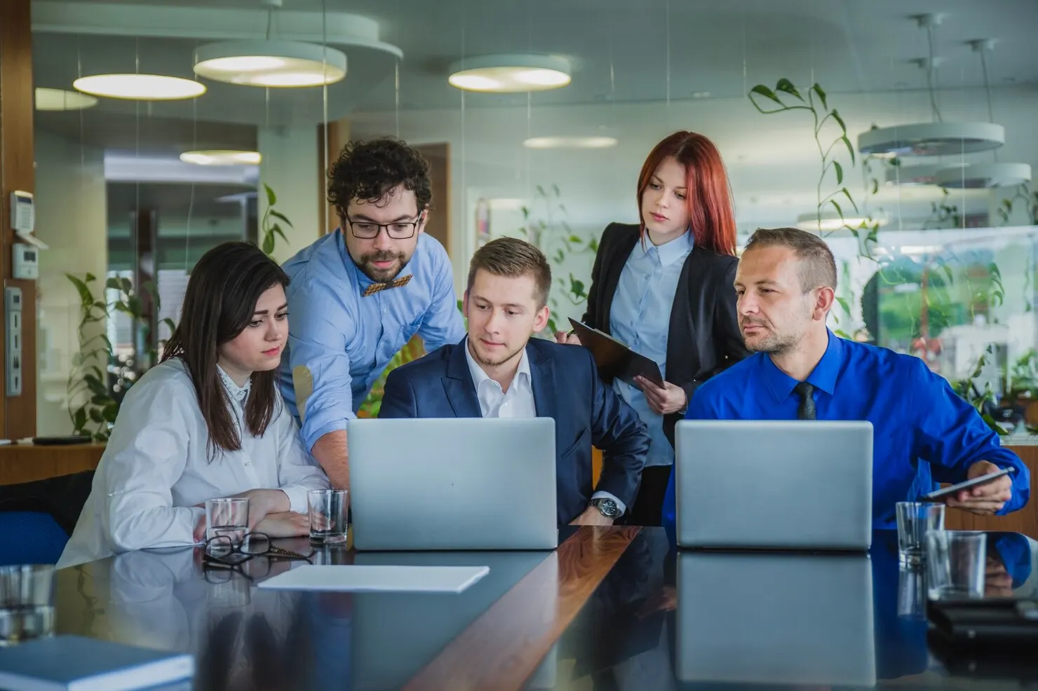 Distributed team collaborating over laptops