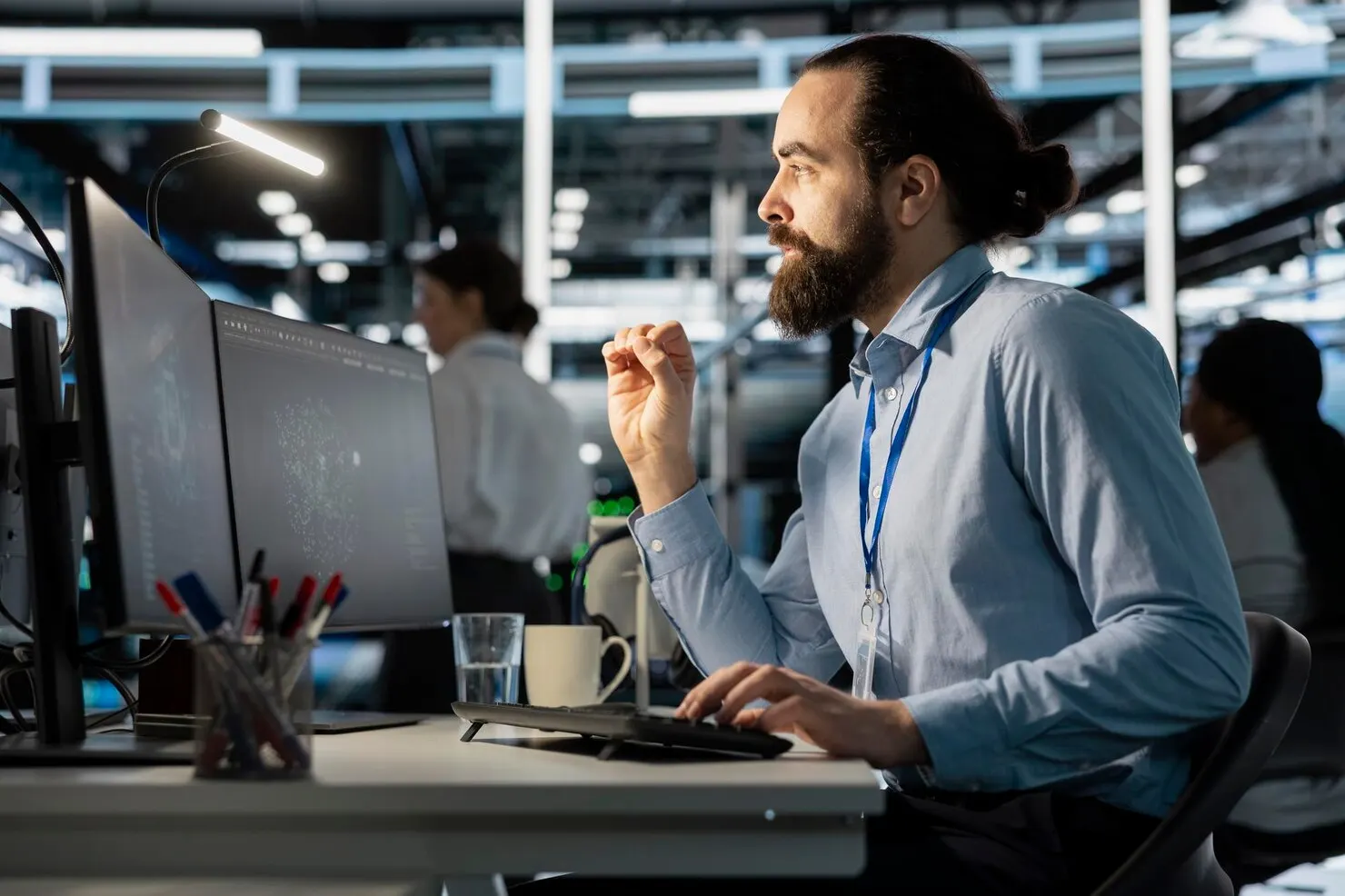 IT professional reviewing data on a monitor